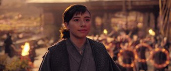 Movie still from “Doctor Strange in the Multiverse of Madness” (2022), directed by Sam Raimi – A person wearing a robe standing in front of a crowd of onlookers; Close Up shot, Over the shoulder angle