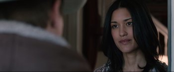 Movie still from “Wind River” (2017), directed by Taylor Sheridan – A woman looking at a man in a room; Close Up shot, Over the shoulder angle