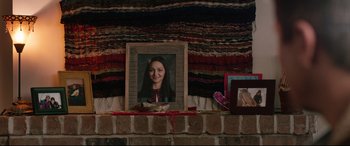 Movie still from “Wind River” (2017), directed by Taylor Sheridan – A picture of a woman in a frame on a mantle; Medium shot, High angle