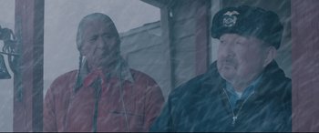 Movie still from “Wind River” (2017), directed by Taylor Sheridan – Two men standing next to each other in the snow; Medium shot, Over the shoulder angle