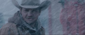 Movie still from “Wind River” (2017), directed by Taylor Sheridan – A man wearing a cowboy hat in the snow; Close Up shot, Low angle
