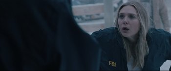Movie still from “Wind River” (2017), directed by Taylor Sheridan – A woman in a black fbi jacket looking at a man; Close Up shot, Over the shoulder angle