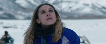 Movie still from “Wind River” (2017), directed by Taylor Sheridan – A woman with long hair looking up into the sky; Close Up shot, Low angle
