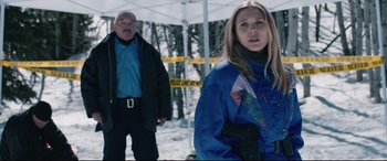 Movie still from “Wind River” (2017), directed by Taylor Sheridan – A man and a woman standing in the snow; Medium shot, Over the shoulder angle