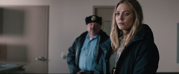 Movie still from “Wind River” (2017), directed by Taylor Sheridan – A man and a woman standing next to each other in a room; Close Up shot, Over the shoulder angle