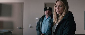 Movie still from “Wind River” (2017), directed by Taylor Sheridan – A man and a woman standing next to each other in a room; Close Up shot, Over the shoulder angle