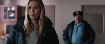 Movie still from “Wind River” (2017), directed by Taylor Sheridan – A woman in a black jacket standing in front of a man; Close Up shot, Over the shoulder angle