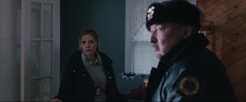 Movie still from “Wind River” (2017), directed by Taylor Sheridan – A woman and a police officer in a room; Medium shot, Over the shoulder angle