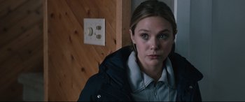 Movie still from “Wind River” (2017), directed by Taylor Sheridan – A young woman in a jacket and a necklace in front of an electrical switch; Close Up shot, Over the shoulder angle