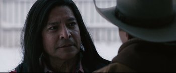 Movie still from “Wind River” (2017), directed by Taylor Sheridan – A man and a woman are talking to each other; Close Up shot, Over the shoulder angle