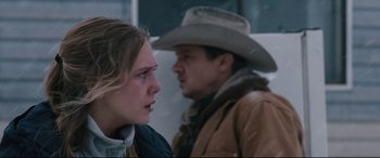 Movie still from “Wind River” (2017), directed by Taylor Sheridan – A man and a woman are looking at each other; Close Up shot, Over the shoulder angle