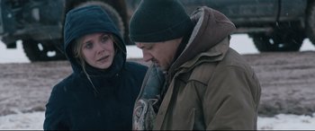 Movie still from “Wind River” (2017), directed by Taylor Sheridan – A man and a woman standing next to each other; Medium shot, Over the shoulder angle