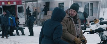 Movie still from “Wind River” (2017), directed by Taylor Sheridan – A man and a woman standing in the snow talking; Medium shot, Over the shoulder angle