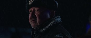 Movie still from “Wind River” (2017), directed by Taylor Sheridan – A person wearing a jacket and a hat; Close Up shot, Low angle