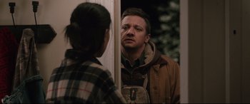 Movie still from “Wind River” (2017), directed by Taylor Sheridan – A man and a woman looking at each other in front of a door; Medium shot, Over the shoulder angle