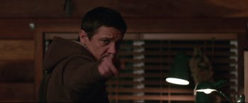 Movie still from “Wind River” (2017), directed by Taylor Sheridan – A man pointing at the camera in a room; Medium shot, Low angle