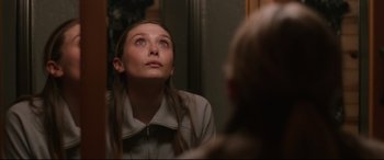 Movie still from “Wind River” (2017), directed by Taylor Sheridan – A woman looking at herself in the mirror; Close Up shot, Over the shoulder angle