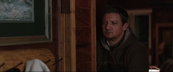 Movie still from “Wind River” (2017), directed by Taylor Sheridan – A man standing next to a wooden door; Close Up shot, Over the shoulder angle