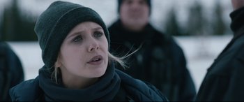 Movie still from “Wind River” (2017), directed by Taylor Sheridan – A person wearing a hat and a scarf; Close Up shot, Over the shoulder angle