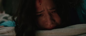 Movie still from “Wind River” (2017), directed by Taylor Sheridan – A person laying on a bed with blood on their face; Close Up shot, Overhead angle