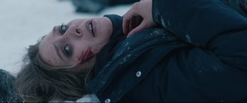Movie still from “Wind River” (2017), directed by Taylor Sheridan – A woman is laying in the snow with blood on her face; Close Up shot, Over the shoulder angle