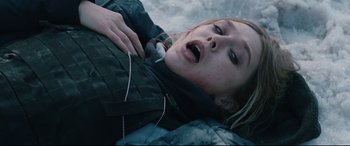 Movie still from “Wind River” (2017), directed by Taylor Sheridan – A woman laying on the ground with her mouth open; Close Up shot, Overhead angle