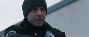 Movie still from “Wind River” (2017), directed by Taylor Sheridan – A person wearing a jacket and a hat; Close Up shot, Low angle
