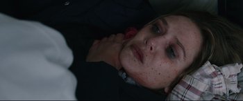 Movie still from “Wind River” (2017), directed by Taylor Sheridan – A young woman is laying down with her hand on her neck; Close Up shot, Overhead angle