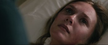 Movie still from “Wind River” (2017), directed by Taylor Sheridan – A person laying in a bed; Close Up shot, Overhead angle