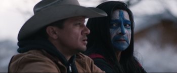 Movie still from “Wind River” (2017), directed by Taylor Sheridan – Two people with blue faces and one is wearing a cowboy hat; Close Up shot, Over the shoulder angle