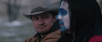 Movie still from “Wind River” (2017), directed by Taylor Sheridan – A man and a woman with face paint and a cowboy hat; Close Up shot, Over the shoulder angle