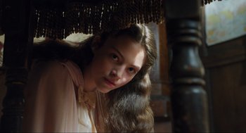 Movie still from “Dolittle” (2020), directed by Stephen Gaghan – A young girl with long brown hair is looking at the camera; Close Up shot, High angle