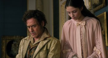 Movie still from “Dolittle” (2020), directed by Stephen Gaghan – A man and a woman standing next to each other; Medium shot, Over the shoulder angle