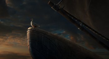 Movie still from “Dolittle” (2020), directed by Stephen Gaghan – A bird sitting on the side of a boat in the water; Wide shot, Low angle