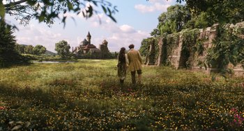 Movie still from “Dolittle” (2020), directed by Stephen Gaghan – A man and a woman are walking through a field; Extreme Wide shot, Low angle
