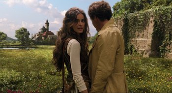 Movie still from “Dolittle” (2020), directed by Stephen Gaghan – A man and a woman standing next to each other in a field; Medium shot, Over the shoulder angle