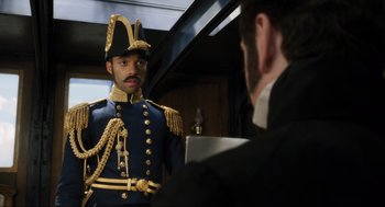 Movie still from “Dolittle” (2020), directed by Stephen Gaghan – A man in a uniform talking to another man in a suit; Medium shot, Over the shoulder angle