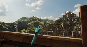 Movie still from “Dolittle” (2020), directed by Stephen Gaghan – A bird sitting on the ledge of a building; Extreme Wide shot, Low angle