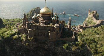 Movie still from “Dolittle” (2020), directed by Stephen Gaghan – An aerial view of a castle on a cliff overlooking the ocean; Extreme Wide shot, High angle