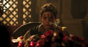 Movie still from “Dolittle” (2020), directed by Stephen Gaghan – A young boy is looking at a bunch of apples; Close Up shot, Over the shoulder angle