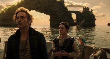Movie still from “Dolittle” (2020), directed by Stephen Gaghan – A man and a woman standing next to a body of water; Medium shot, Over the shoulder angle