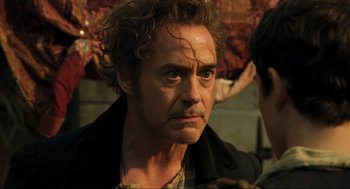 Movie still from “Dolittle” (2020), directed by Stephen Gaghan – A person wearing a jacket; Close Up shot, Over the shoulder angle