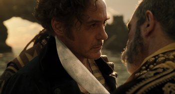 Movie still from “Dolittle” (2020), directed by Stephen Gaghan – A person with a knife in his mouth; Close Up shot, Over the shoulder angle