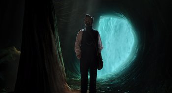 Movie still from “Dolittle” (2020), directed by Stephen Gaghan – A man standing in front of an underground tunnel; Wide shot, Low angle