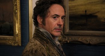 Movie still from “Dolittle” (2020), directed by Stephen Gaghan – A person wearing a jacket; Close Up shot, Over the shoulder angle