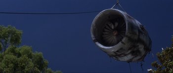Movie still from “Donnie Darko” (2001), directed by Richard Kelly – An airplane landing gear hanging from a wire; Extreme Wide shot, Low angle