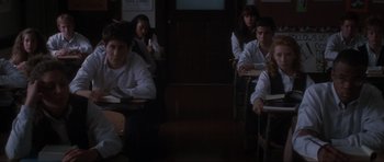 Movie still from “Donnie Darko” (2001), directed by Richard Kelly – A group of people sitting in a room; Medium shot, High angle