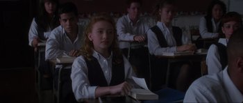 Movie still from “Donnie Darko” (2001), directed by Richard Kelly – A group of people sitting in a classroom; Medium shot, Over the shoulder angle