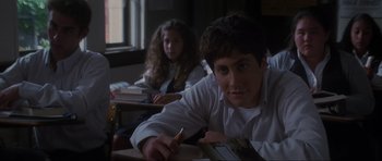 Movie still from “Donnie Darko” (2001), directed by Richard Kelly – A man and a woman sitting at a desk in front of a window; Close Up shot, Over the shoulder angle
