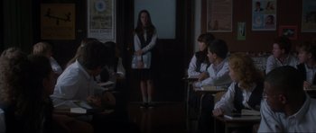 Movie still from “Donnie Darko” (2001), directed by Richard Kelly – A group of people sitting in a room with papers; Wide shot, Over the shoulder angle